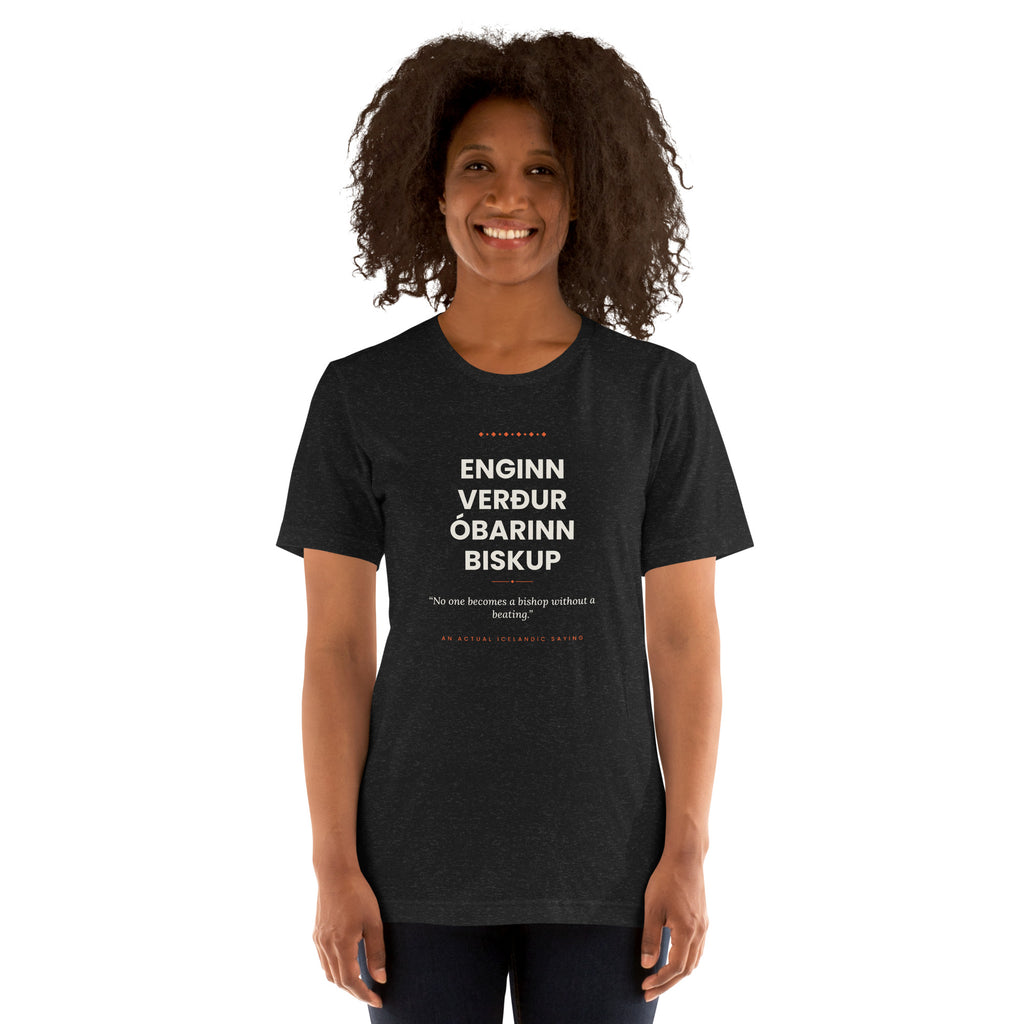 Female model wearing the Black Heather Enginn verður óbarinn biskup tee, showing the front print and unisex fit.