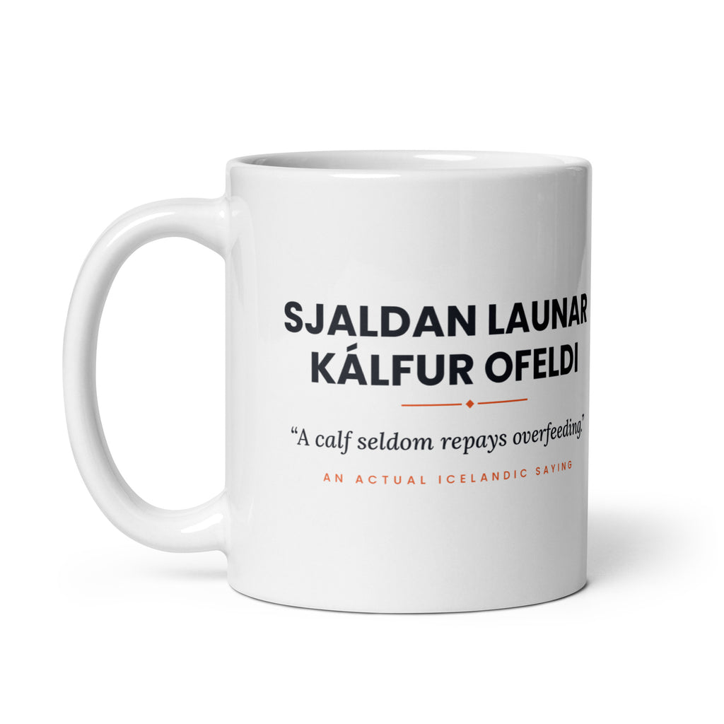 White 11 oz Sjaldan launar kálfur ofeldi mug, handle on the left, showing the repeated saying on the other side.