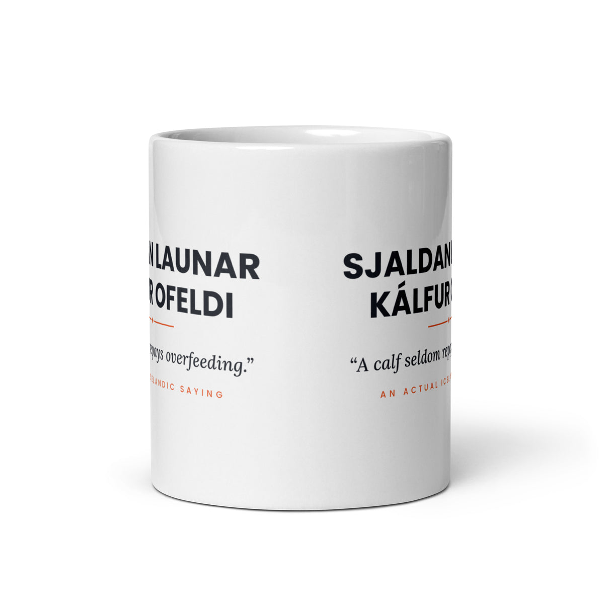 View opposite the handle of the white 11 oz Sjaldan launar kálfur ofeldi mug, showing the gap between the two repeats of the design.
