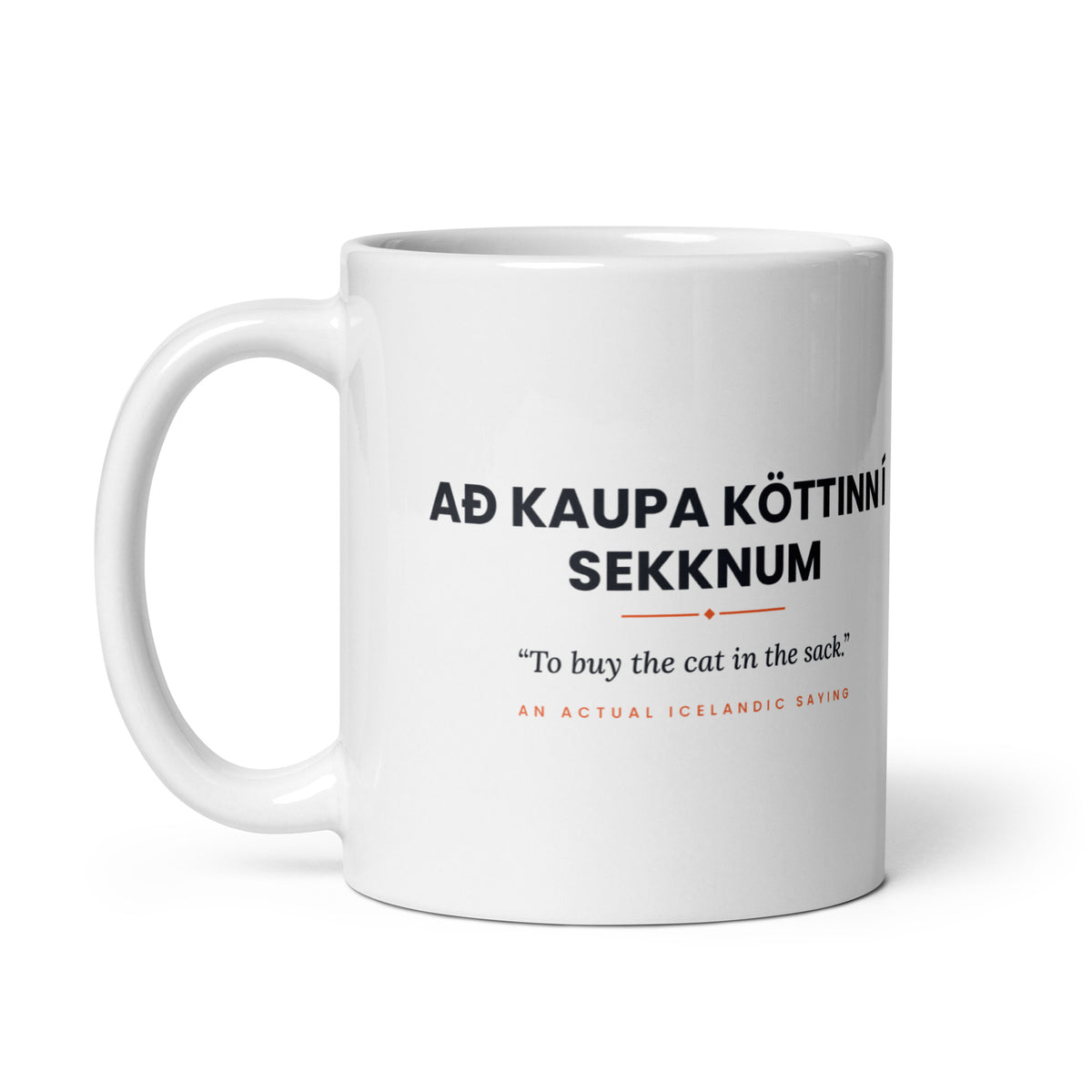 White 11 oz Að kaupa köttinn í sekknum mug, handle on the left, showing the repeated saying on the other side.