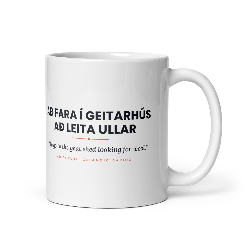 White 11 oz Að fara í geitarhús að leita ullar mug, handle on the right, showing black lettering, English translation and coral accents.