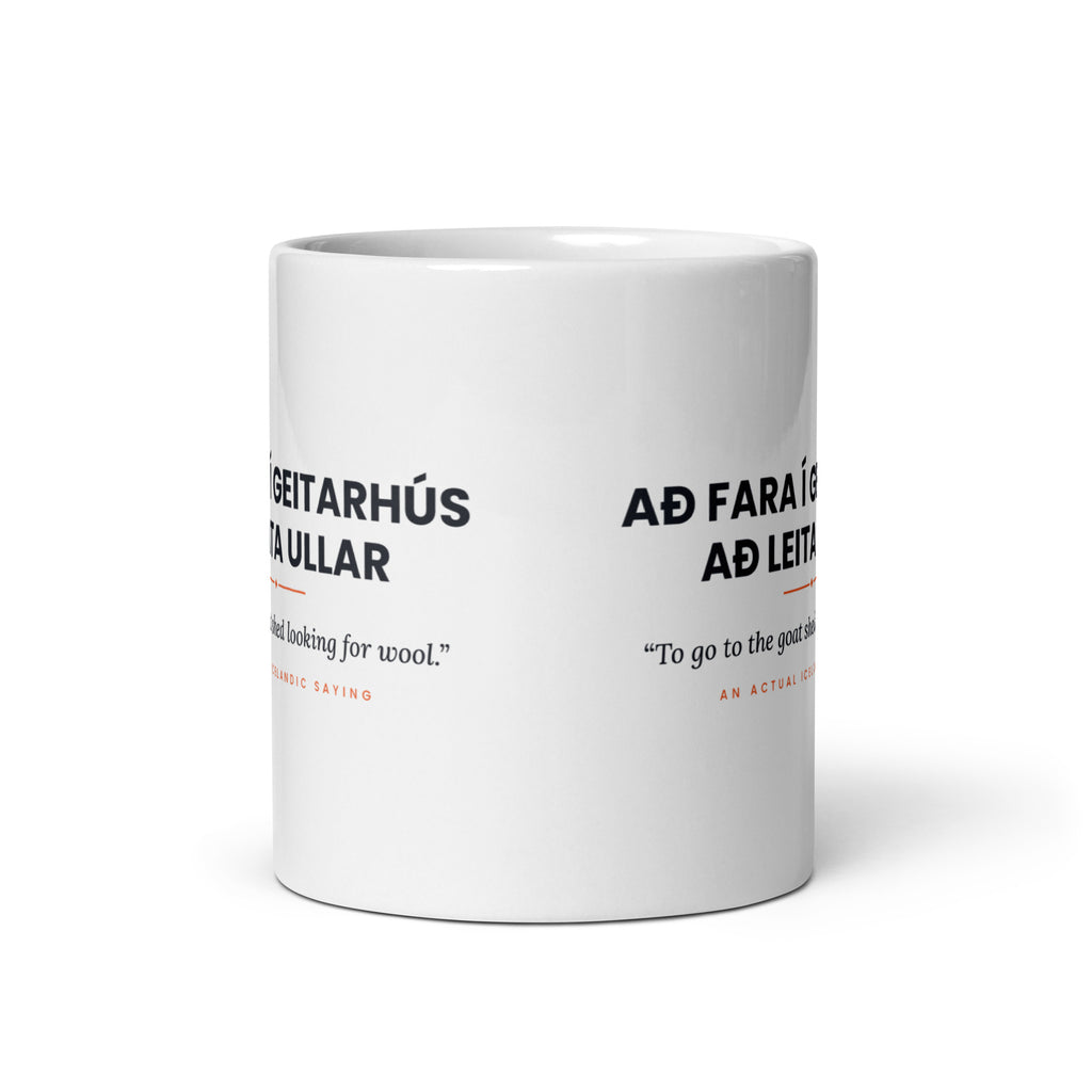 View opposite the handle of the white 11 oz Að fara í geitarhús að leita ullar mug, showing the gap between the two repeats of the design.