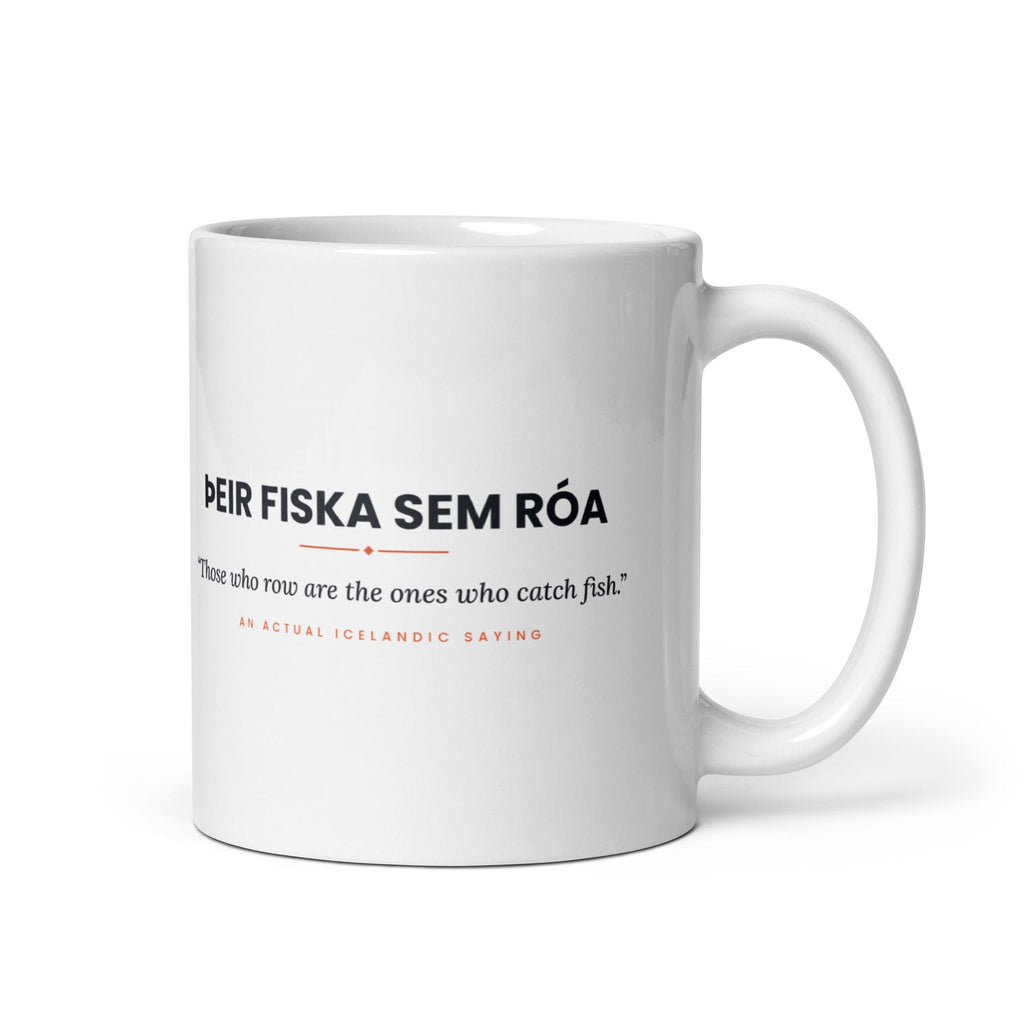 White 11 oz Þeir fiska sem róa mug, handle on the right, showing black lettering, English translation and coral accents.