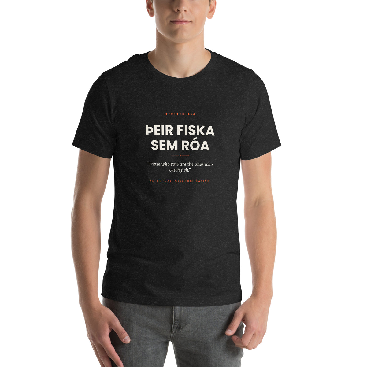 Male model wearing the Black Heather Þeir fiska sem róa tee, showing the front print and unisex fit.