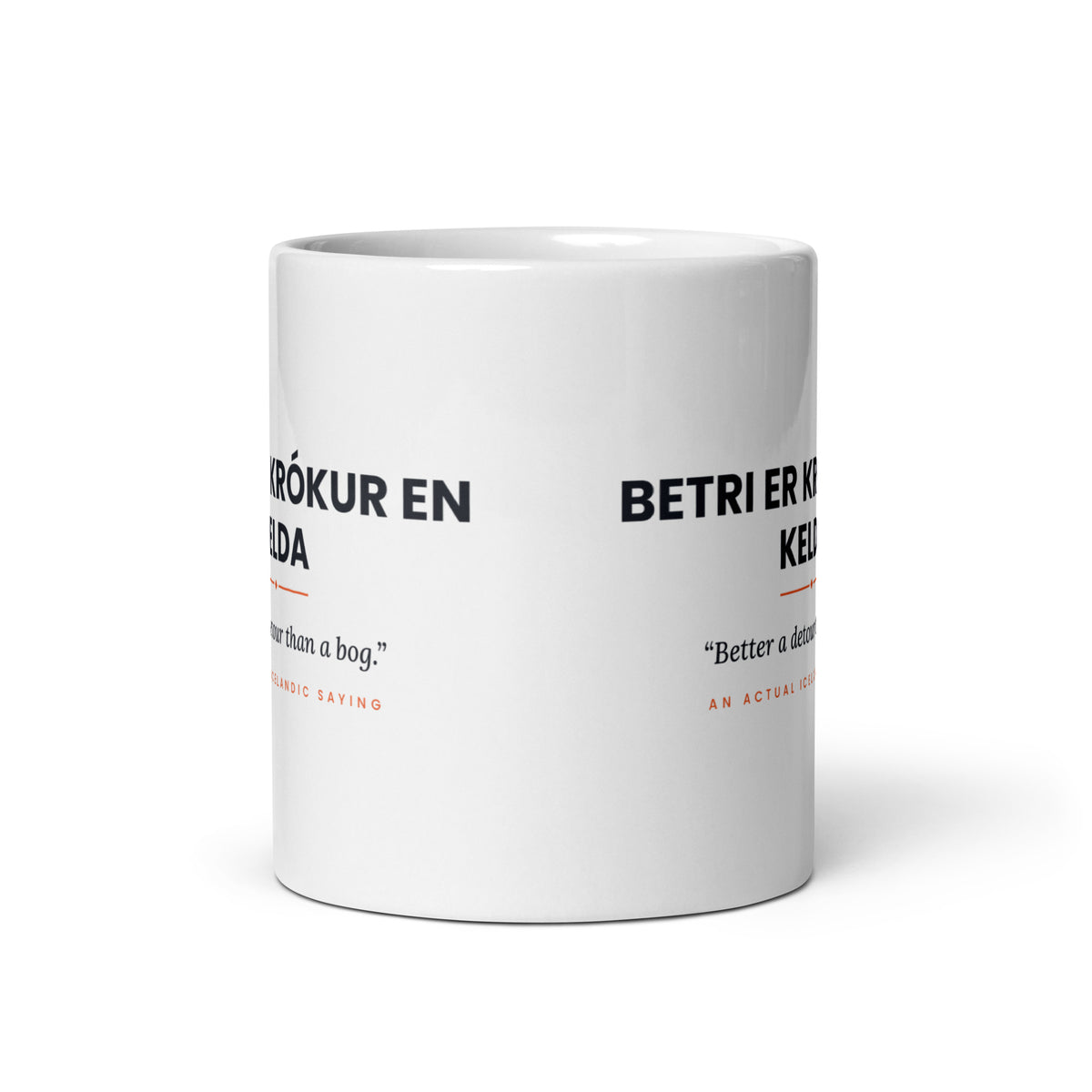 View opposite the handle of the white 11 oz Betri er krókur en kelda mug, showing the gap between the two repeats of the design.