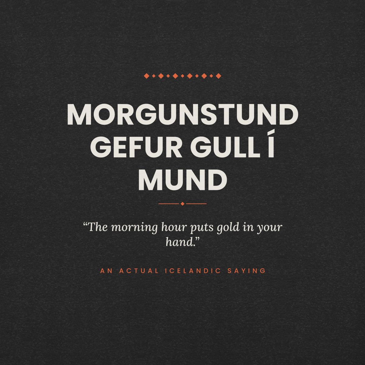 Close-up of the Morgunstund gefur gull í mund front print, showing cream lettering, English translation and coral accents on Black Heather fabric.