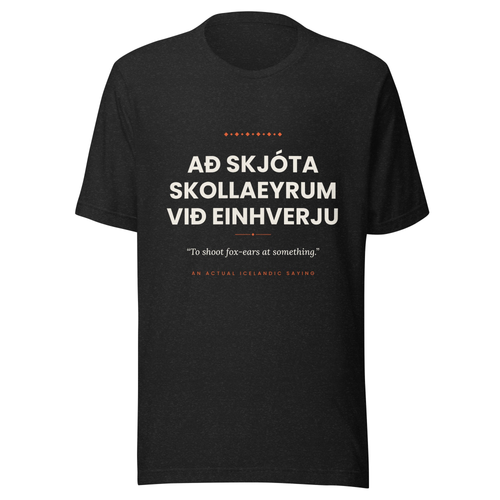 Front view of the Black Heather Að skjóta skollaeyrum við einhverju tee, with cream lettering, English translation and coral accents.