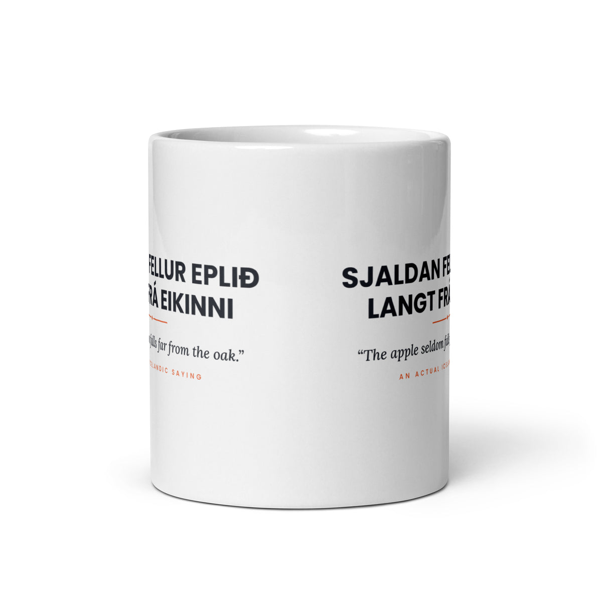 View opposite the handle of the white 11 oz Sjaldan fellur eplið langt frá eikinni mug, showing the gap between the two repeats of the design.