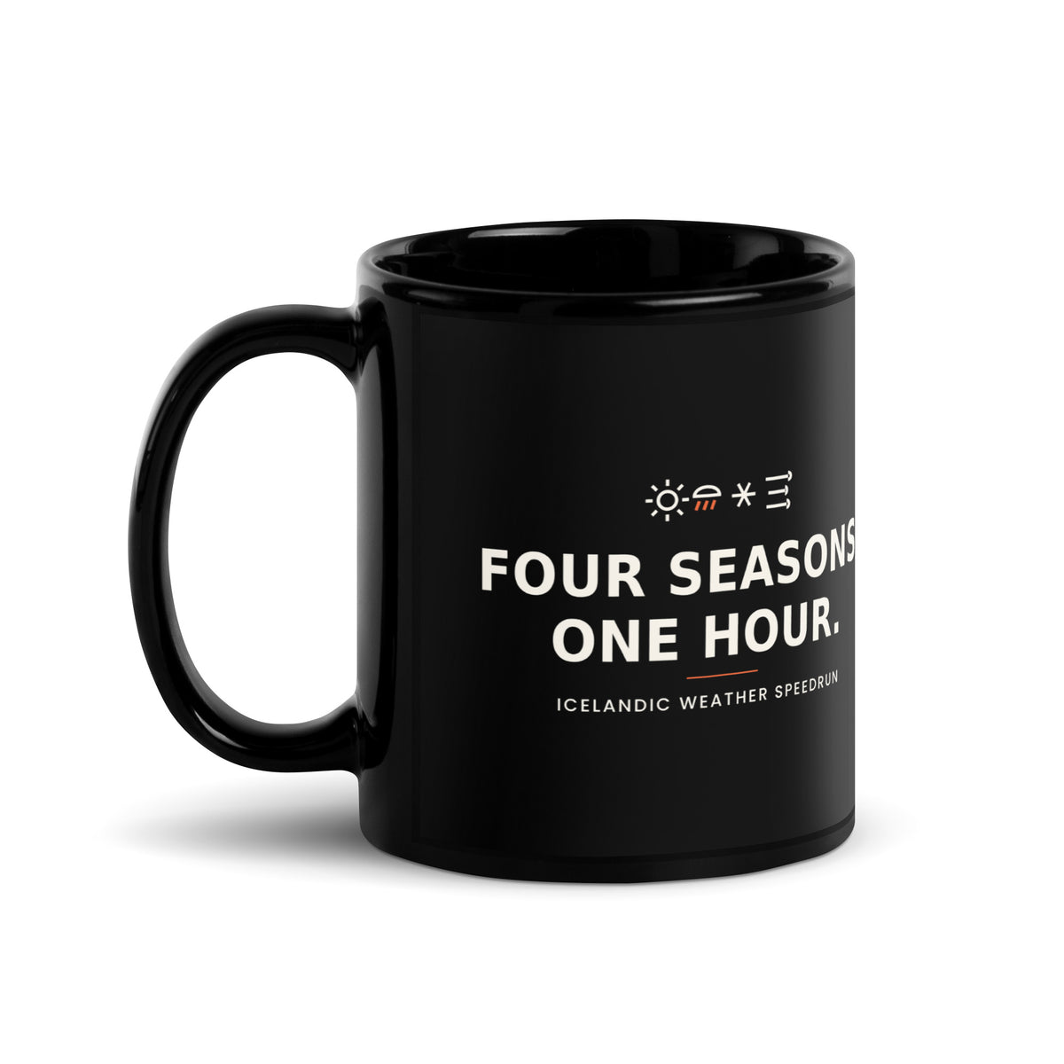 Black 11 oz Four Seasons. One Hour. mug, handle on the left, showing the printed slogan.