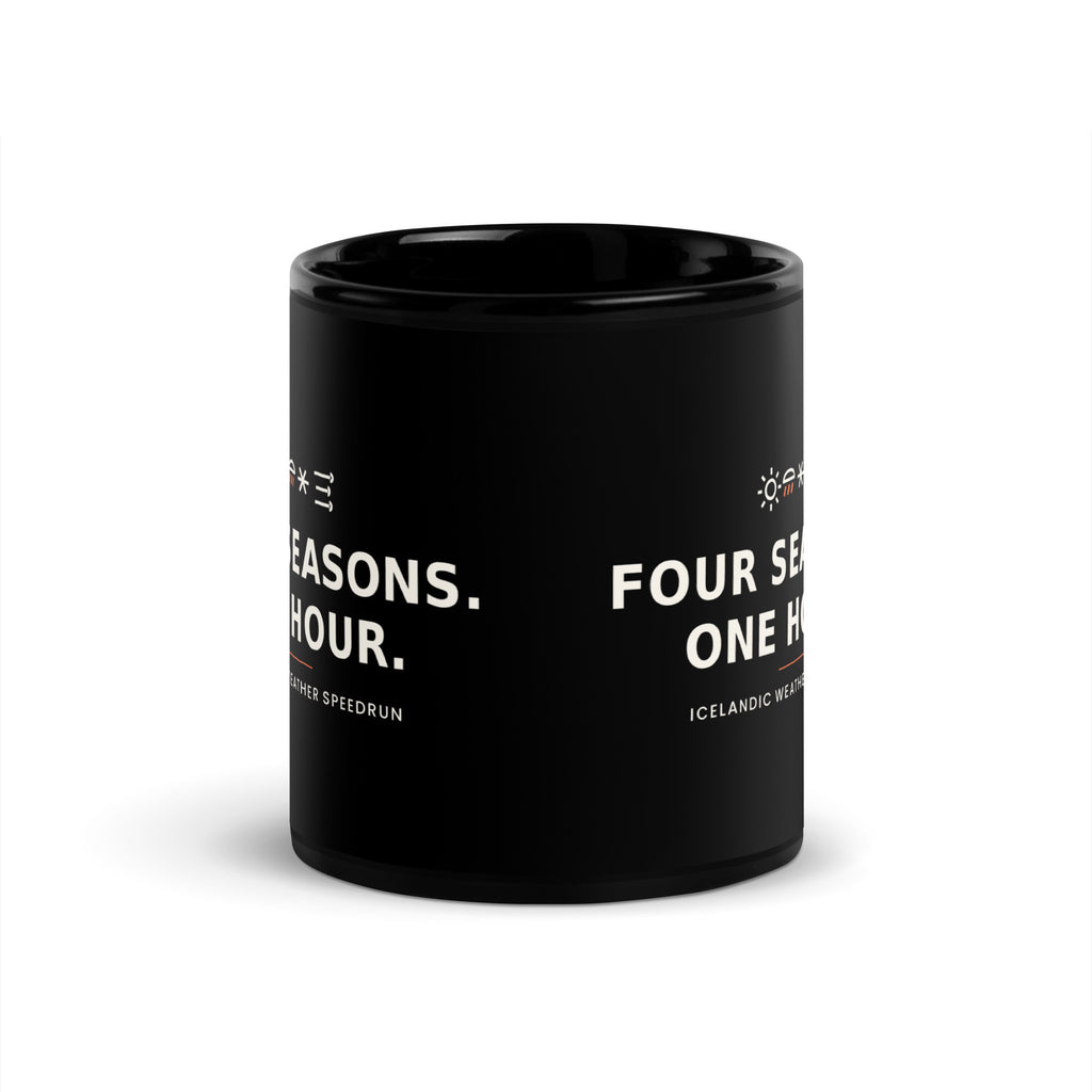 Black 11 oz Four Seasons. One Hour. mug, viewed opposite the handle, showing the gap between the repeated slogans.