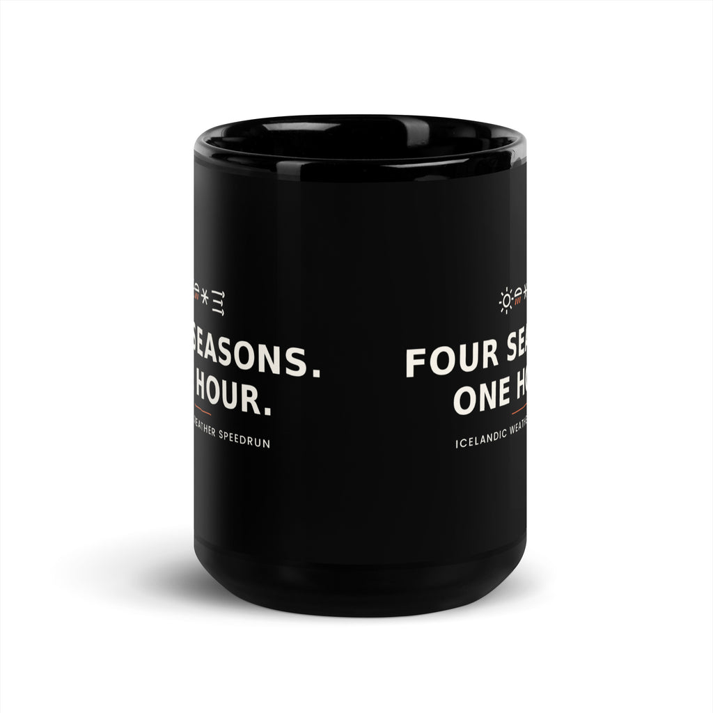 Black 15 oz Four Seasons. One Hour. mug, viewed opposite the handle, showing the gap between the repeated slogans.
