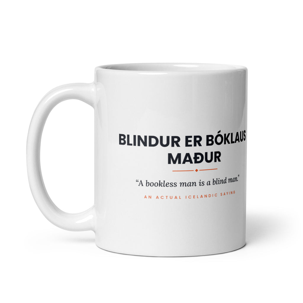 White 11 oz Blindur er bóklaus maður mug, handle on the left, showing the repeated saying on the other side.