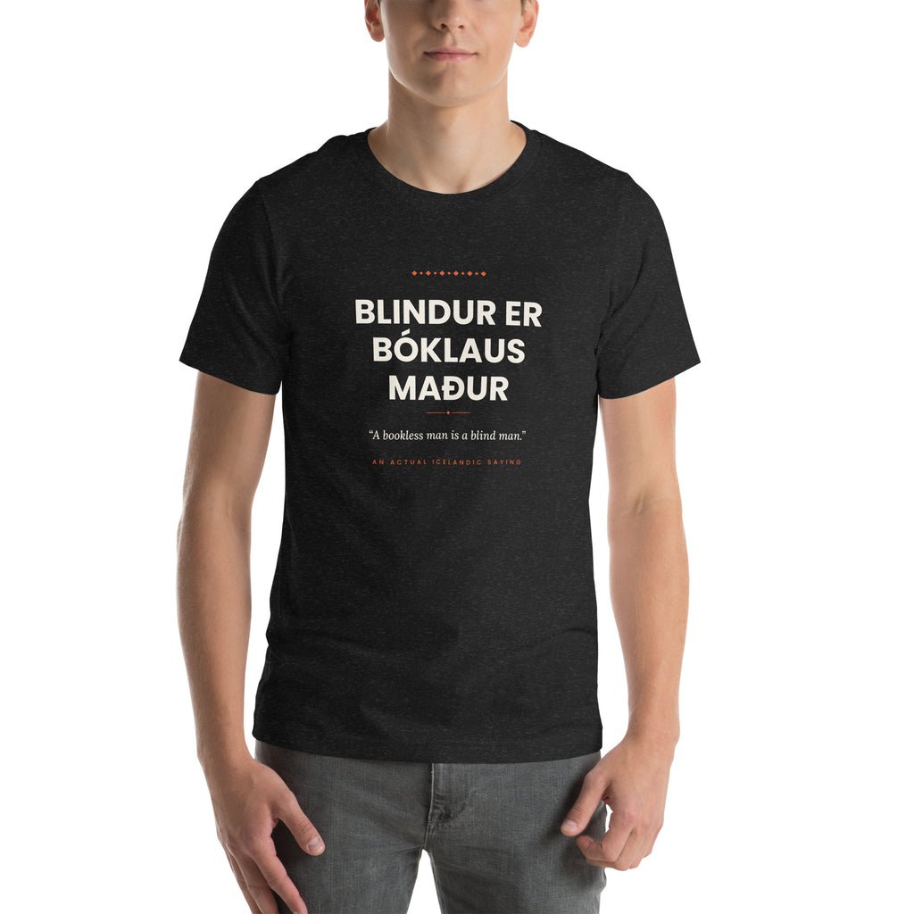 Male model wearing the Black Heather Blindur er bóklaus maður tee, showing the front print and unisex fit.