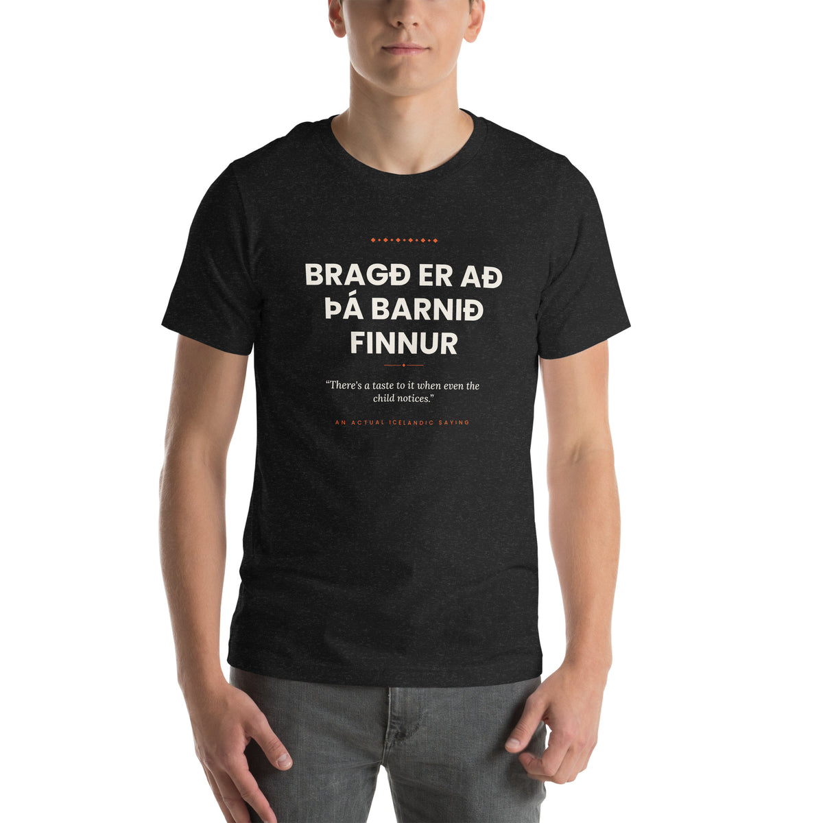 Male model wearing the Black Heather Bragð er að þá barnið finnur tee, showing the front print and unisex fit.