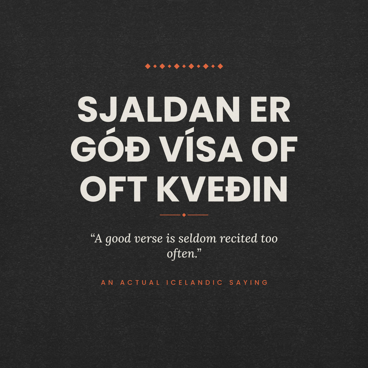 Close-up of the Sjaldan er góð vísa of oft kveðin front print, showing cream lettering, English translation and coral accents on Black Heather fabric.