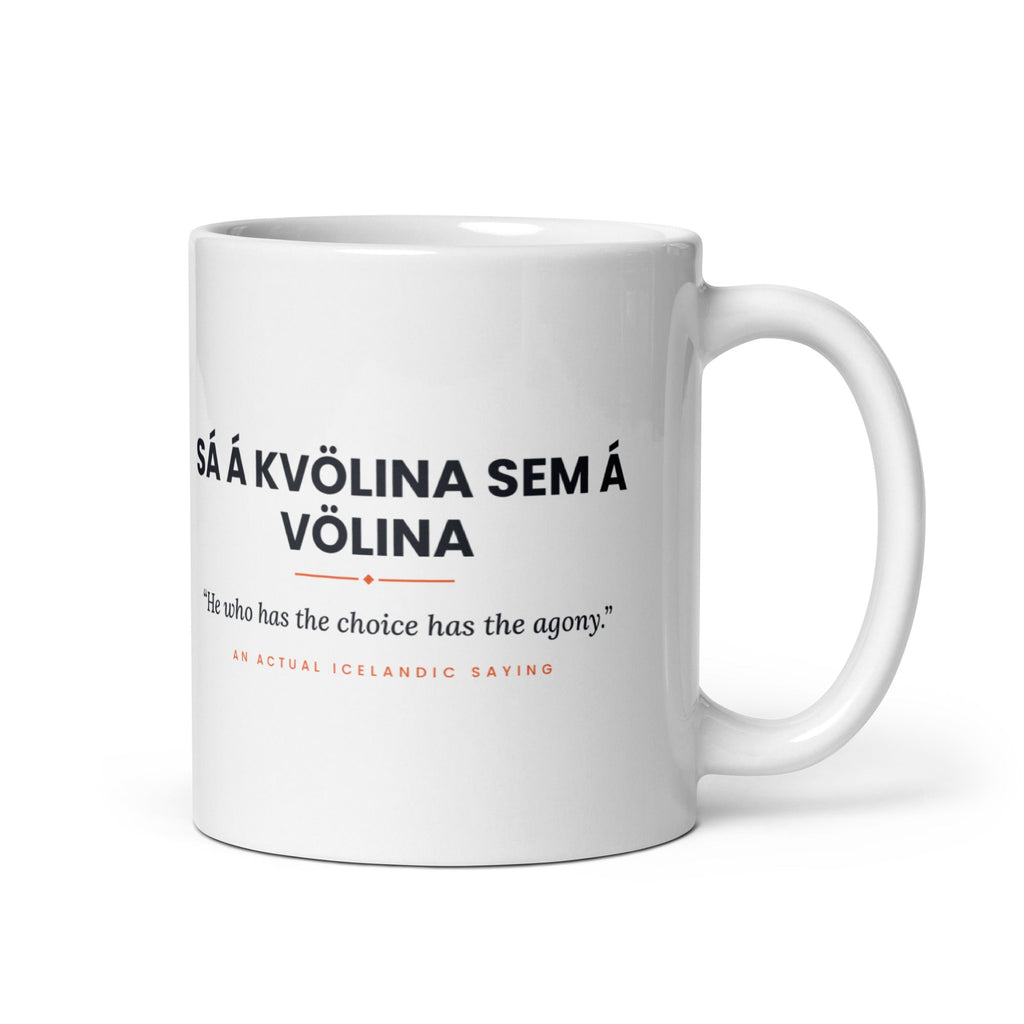 White 11 oz Sá á kvölina sem á völina mug, handle on the right, showing black lettering, English translation and coral accents.