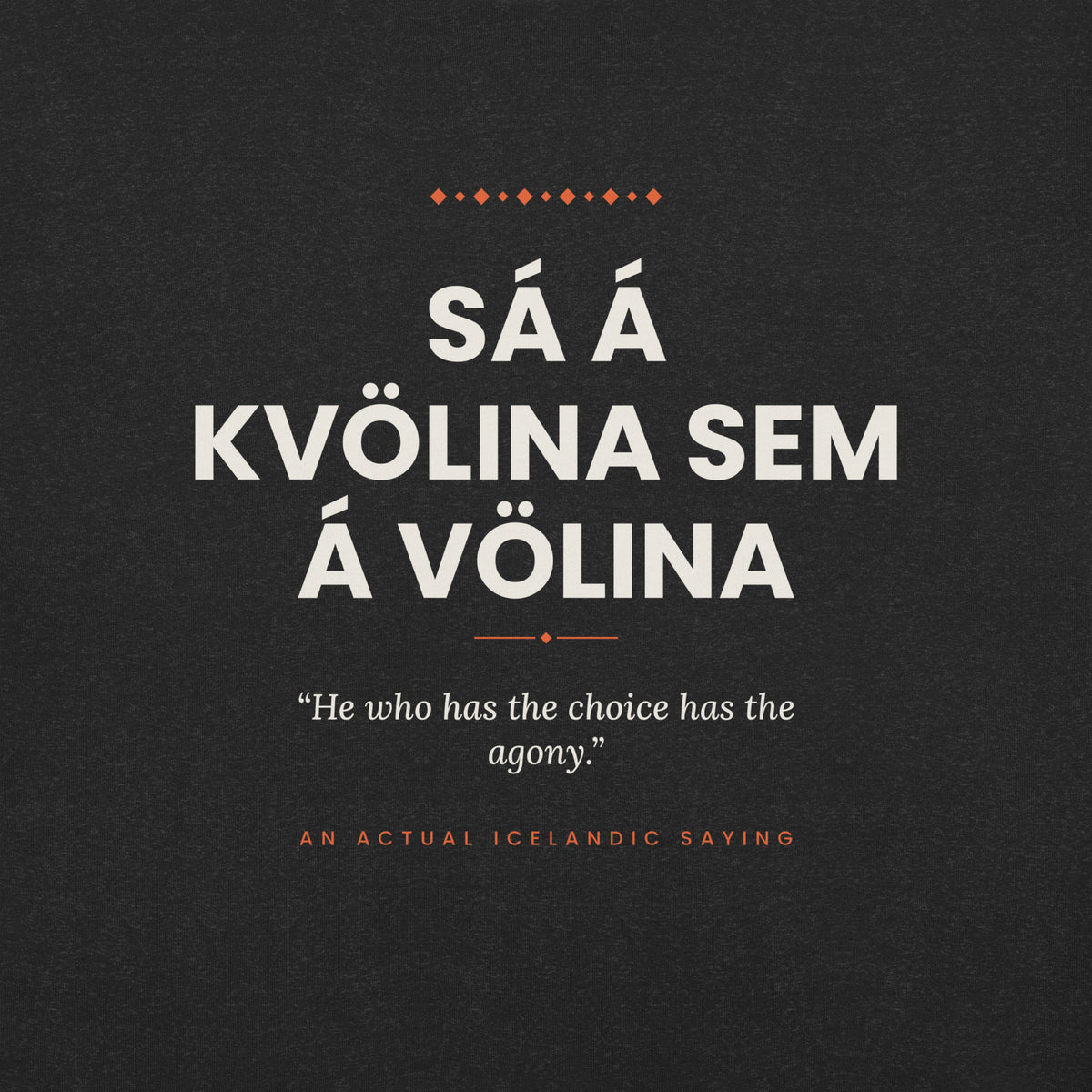 Close-up of the Sá á kvölina sem á völina front print, showing cream lettering, English translation and coral accents on Black Heather fabric.