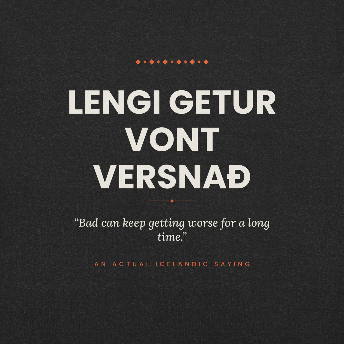 Close-up of the Lengi getur vont versnað front print, showing cream lettering, English translation and coral accents on Black Heather fabric.