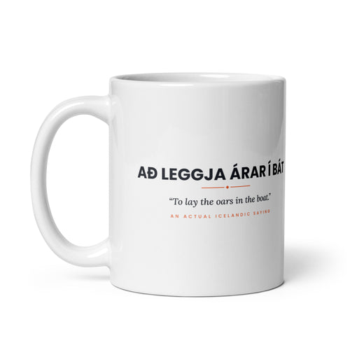 White 11 oz Að leggja árar í bát mug, handle on the left, showing the repeated saying on the other side.