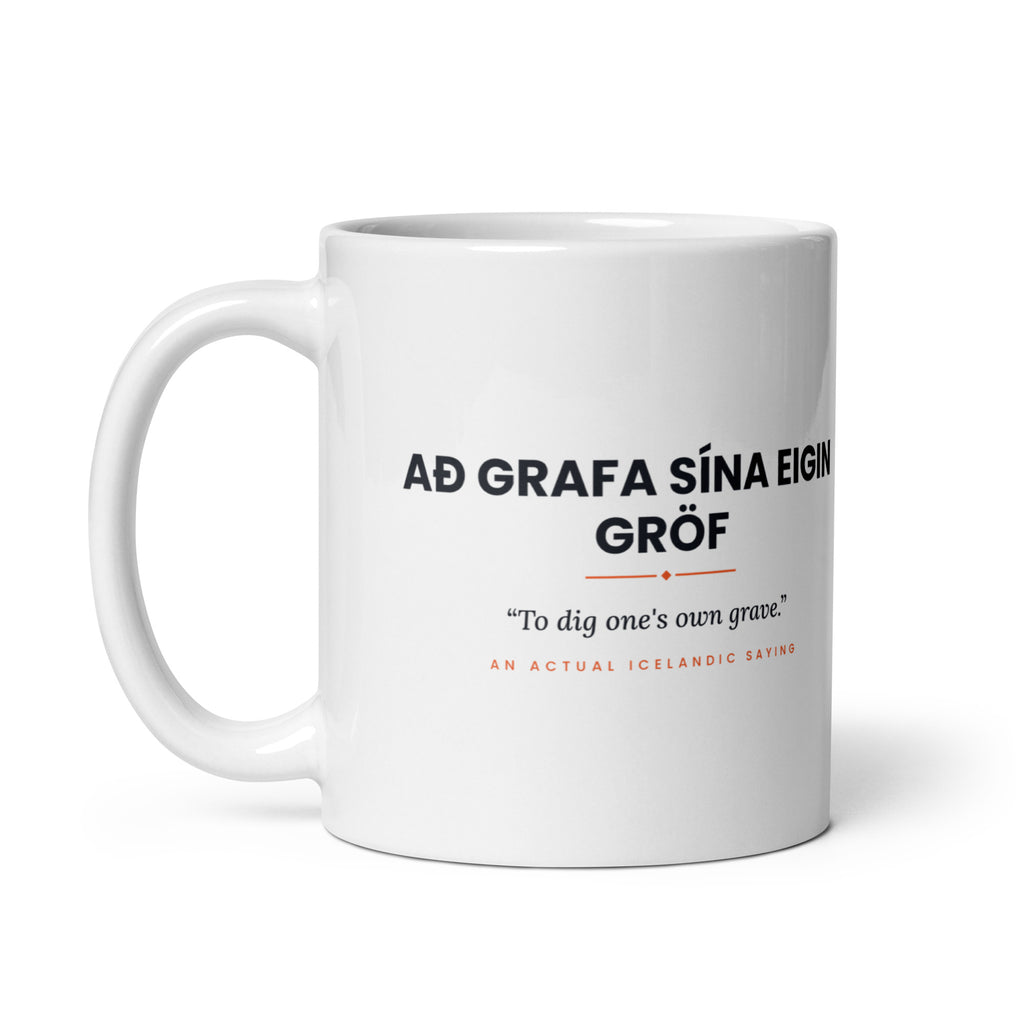White 11 oz Að grafa sína eigin gröf mug, handle on the left, showing the repeated saying on the other side.