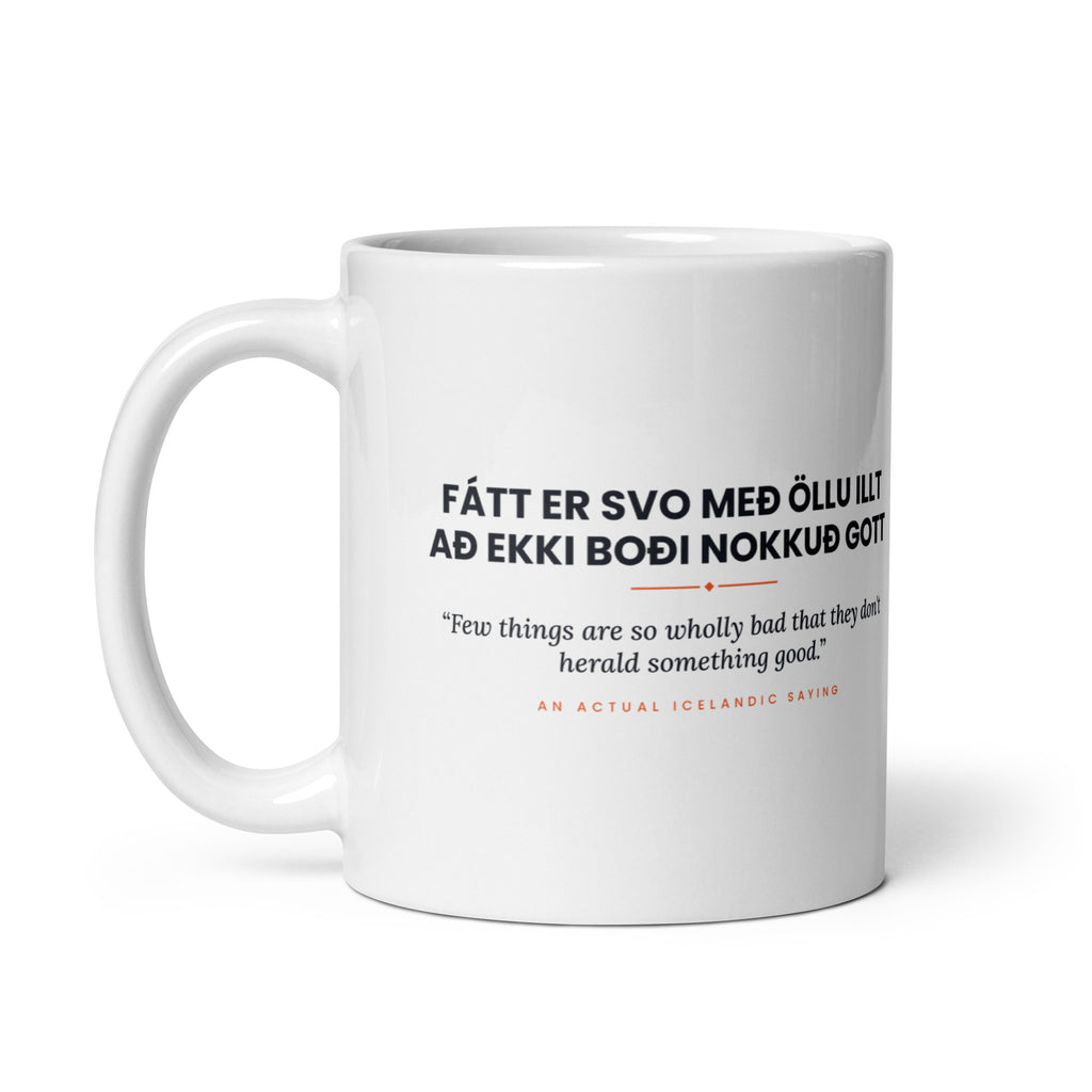 White 11 oz Fátt er svo með öllu illt að ekki boði nokkuð gott mug, handle on the left, showing the repeated saying on the other side.