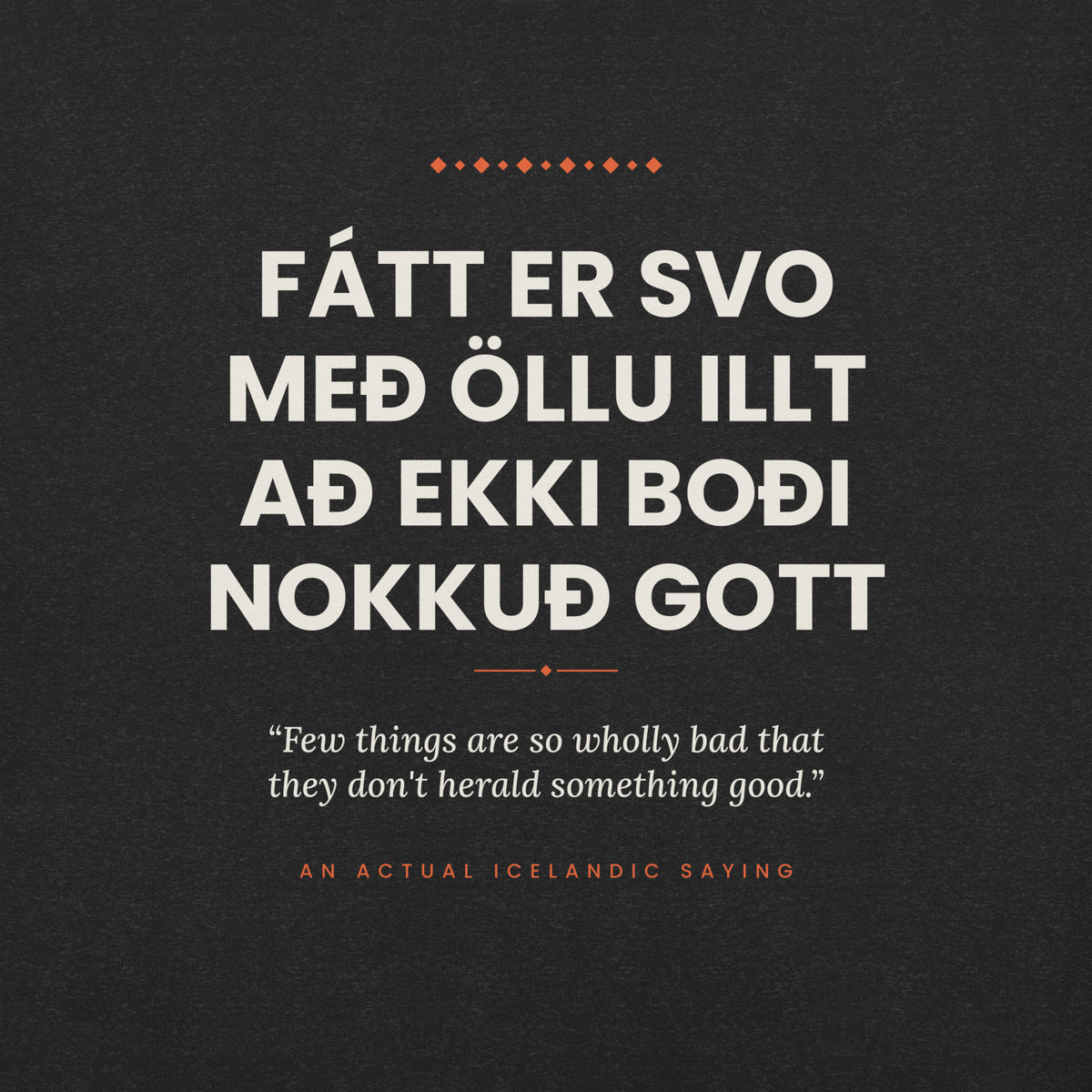 Close-up of the Fátt er svo með öllu illt að ekki boði nokkuð gott front print, showing cream lettering, English translation and coral accents on Black Heather fabric.