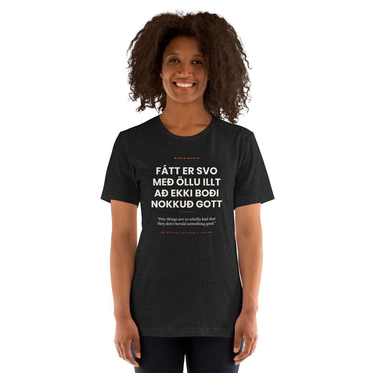 Female model wearing the Black Heather Fátt er svo með öllu illt að ekki boði nokkuð gott tee, showing the front print and unisex fit.