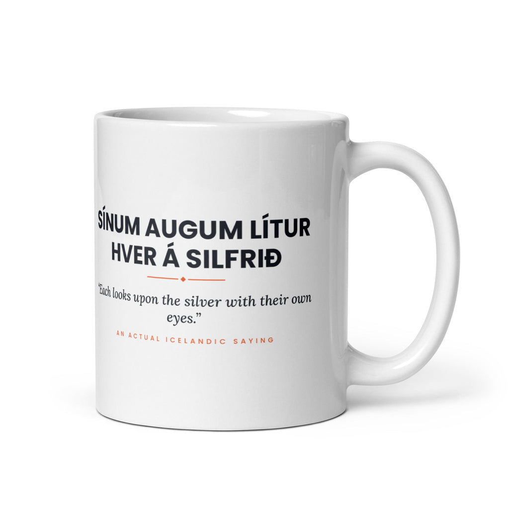 White 11 oz Sínum augum lítur hver á silfrið mug, handle on the right, showing black lettering, English translation and coral accents.