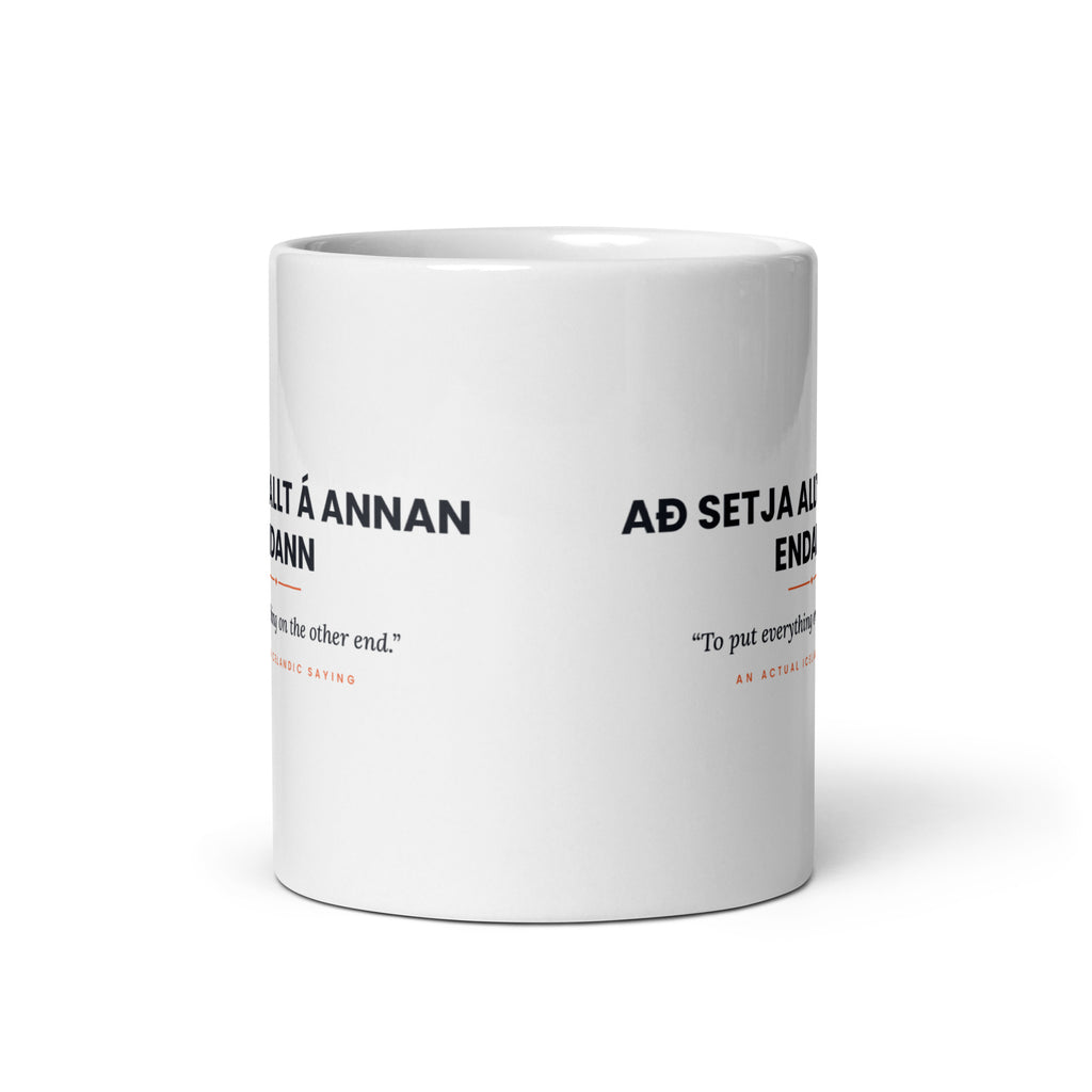 View opposite the handle of the white 11 oz Að setja allt á annan endann mug, showing the gap between the two repeats of the design.