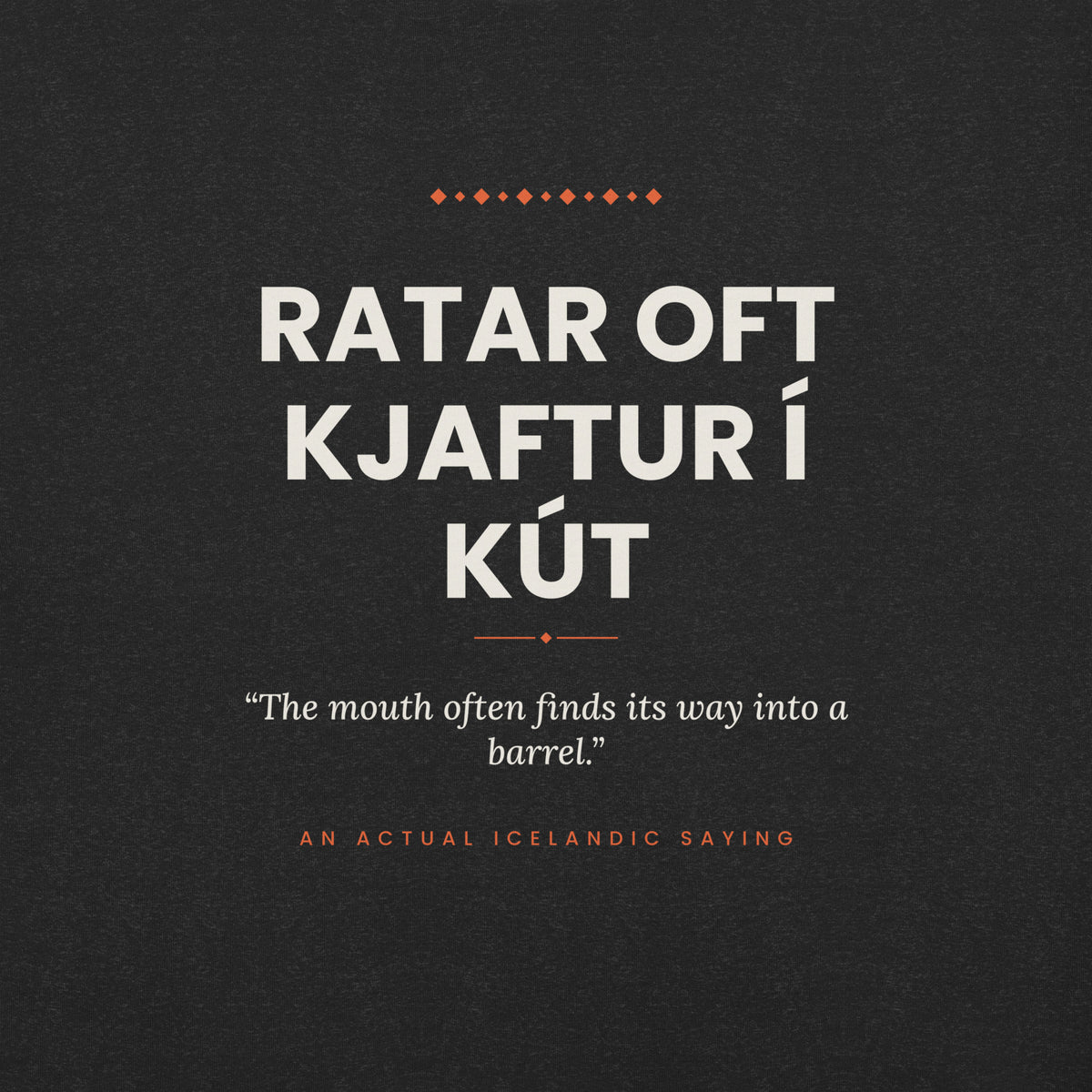 Close-up of the Ratar oft kjaftur í kút front print, showing cream lettering, English translation and coral accents on Black Heather fabric.