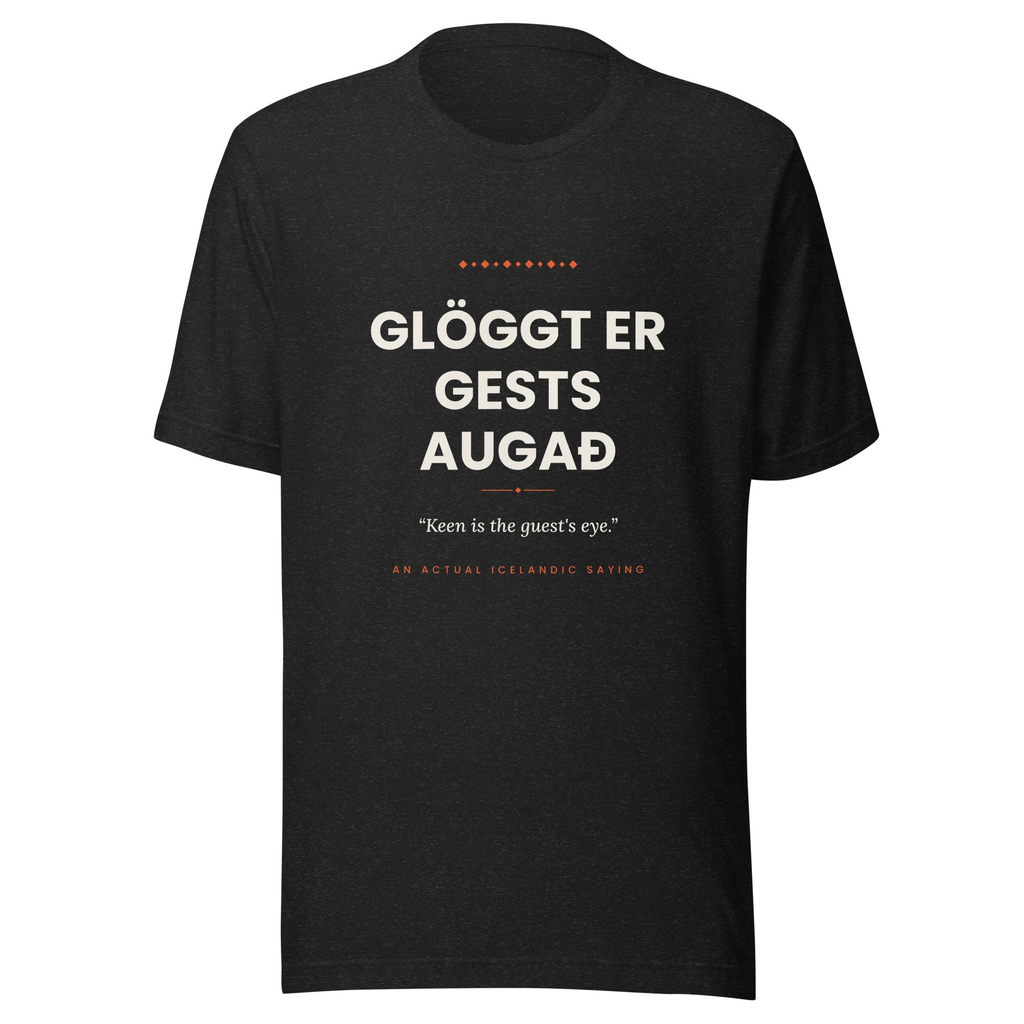 Front view of the Black Heather Glöggt er gests augað tee, with cream lettering, English translation and coral accents.