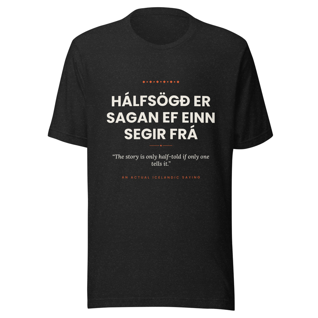 Front view of the Black Heather Hálfsögð er sagan ef einn segir frá tee, with cream lettering, English translation and coral accents.