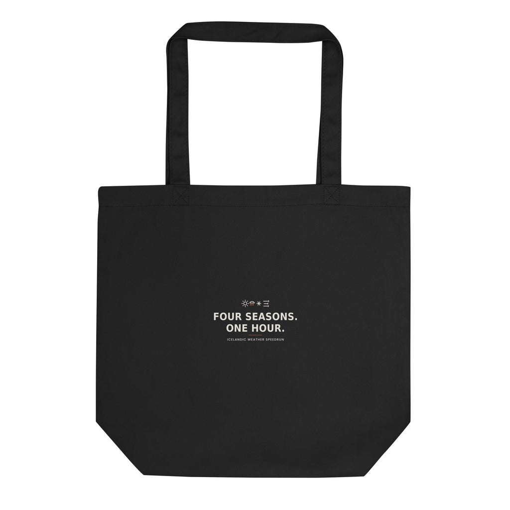 Front view of the Black Four Seasons. One Hour. tote, showing its handles and printed design.