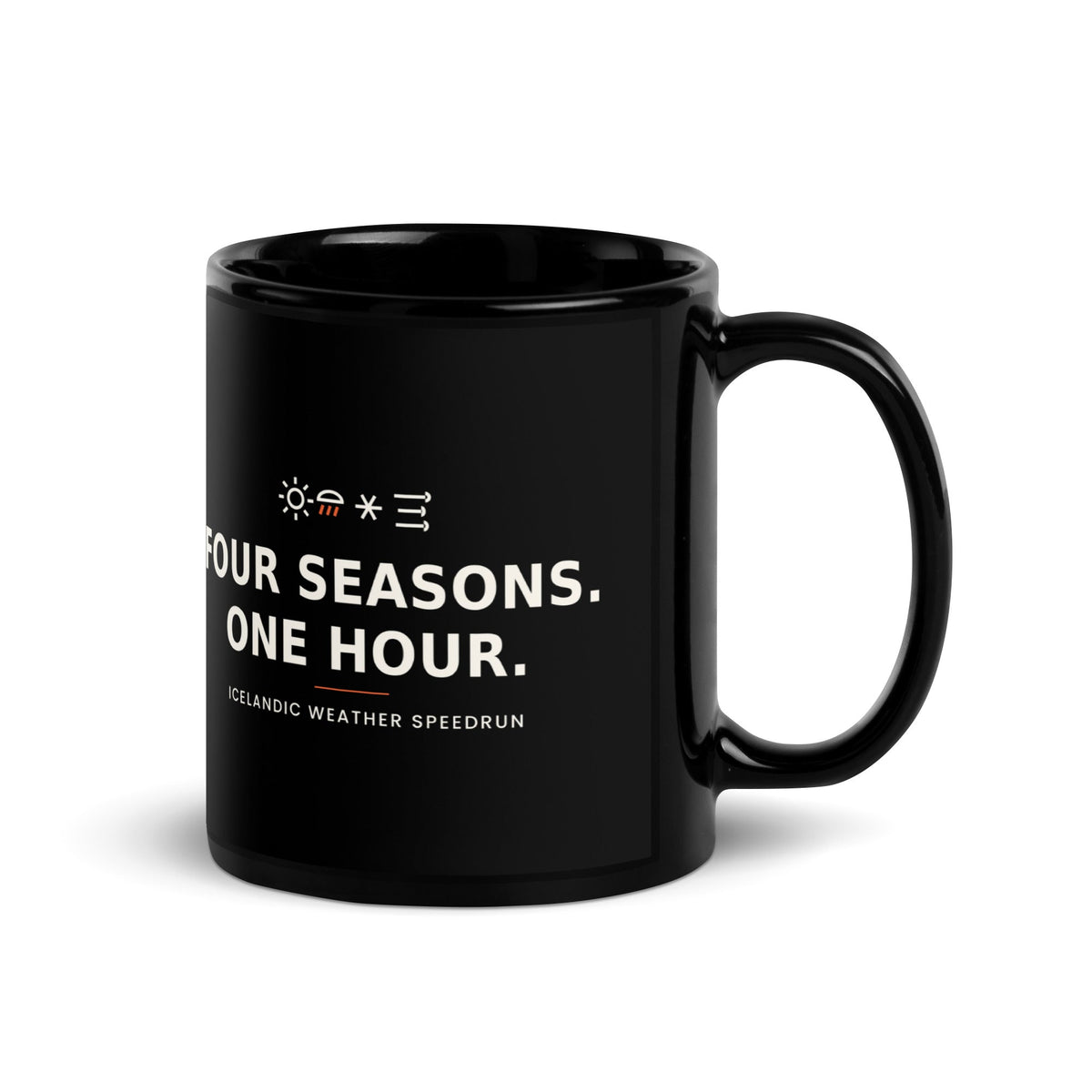 Black 11 oz Four Seasons. One Hour. mug, handle on the right, showing the printed slogan.