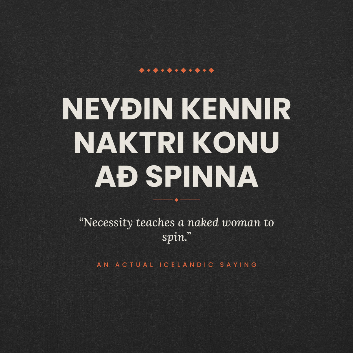Close-up of the cream Icelandic saying and English translation with coral accents on the Black Heather tee.